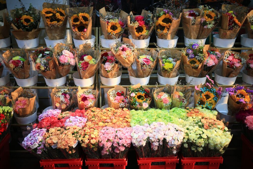 Vibrant flower bouquets in full bloom on display for same-day delivery at an outdoor market in Kolkata. Perfect for spring decor.